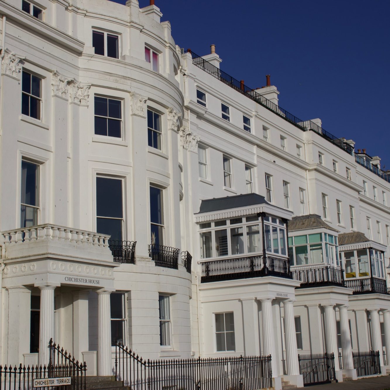 Victorian-style white building with bay windows.