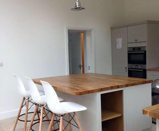 Construction site with scaffolding, signage, and a portable toilet.
